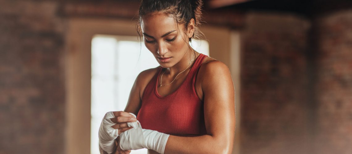 Female boxer wearing strap on wrist