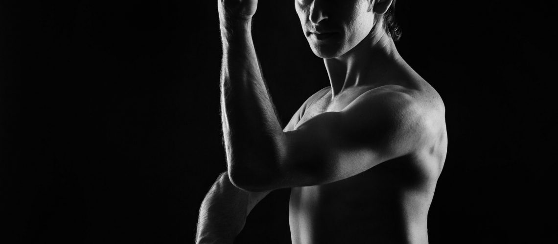 Kung Fu athlete performs kata defense. Low key. The concept of martial arts.